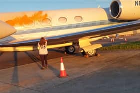 A screen grab taken from a handout video of Just Stop Oil protesters spraying orange paint over parked private jets at London Stansted Airport in Essex. Picture: Just Stop Oil/PA Wire