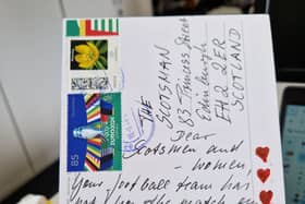 The woman decorated her postcard with hearts