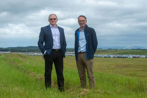 Crosswind Developments chief executive John Watson and project director David Kelman with the former Edinburgh Airport runway occupied by valet parking to the right behind them. (Photo by Lisa Ferguson/The Scotsman)