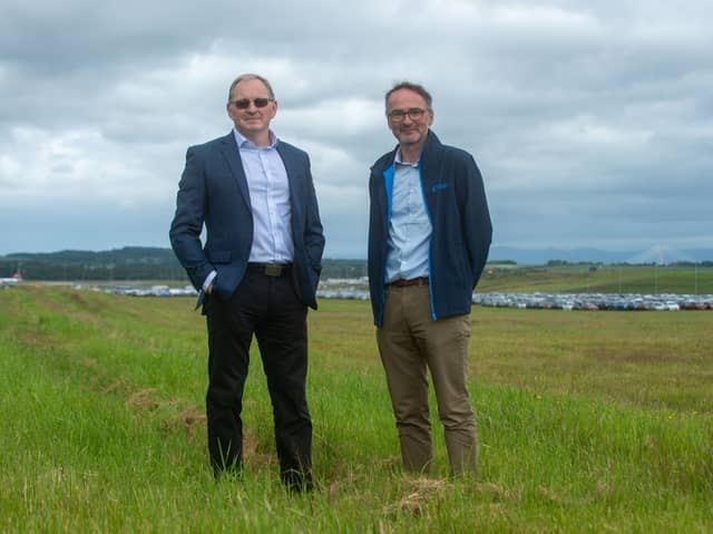 Crosswind Developments chief executive John Watson and project director David Kelman with the former Edinburgh Airport runway occupied by valet parking to the right behind them. (Photo by Lisa Ferguson/The Scotsman)