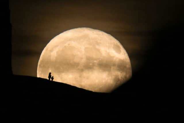 A Beaver Moon rises behind the Grade I listed St Michael's Tower on the top of Glastonbury Tor in 2017.