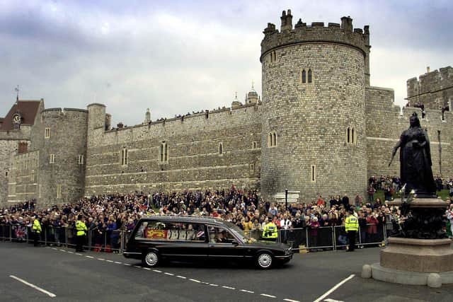 The Queen Mother’s funeral cortege passes the Queen Victoria memorial statue outside Windsor Castle on April 9 2002. Royal dignitaries and politicians from around the world gathered in London to pay their last respects to the Queen Mother who died March 30, aged 101.