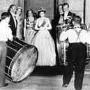 John Warden Brooke, 2nd Viscount Brookeborough (L), Queen Elizabeth II (C) and her husband Prince Philip, Duke of Edinburgh listen to drummers, on July 3, 1953 during their official visit to Northern Ireland.