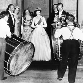 John Warden Brooke, 2nd Viscount Brookeborough (L), Queen Elizabeth II (C) and her husband Prince Philip, Duke of Edinburgh listen to drummers, on July 3, 1953 during their official visit to Northern Ireland.