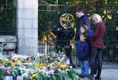 Members of the public look at floral tributes at Balmoral in Scotland following the death of Queen Elizabeth II on Thursday. Picture date: Saturday September 10, 2022. (Photo: PA)