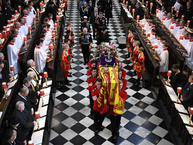 Soldiers of The Queen’s Company of the Grenadier Guards carry the coffin of Queen Elizabeth II
