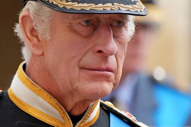 King Charles III follows the coffin of Queen Elizabeth II as it travels inside Windsor Castle on September 19. 