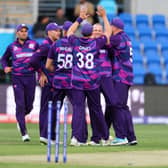 Scotlands Michael Leask (C) celebrates with teammates after dismissing West Indies captain Nicholas Pooran