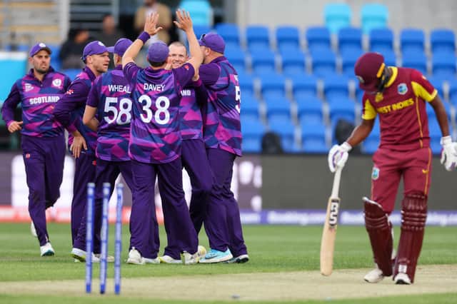 Scotlands Michael Leask (C) celebrates with teammates after dismissing West Indies captain Nicholas Pooran