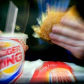  A man eats his lunch at a Burger King restaurant.