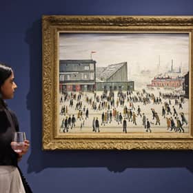 A visitor walks past "Going to the Match" by English artist LS Lowry from 1928, on display at a Christie's exhibition in Dubai on September 15, 2022
