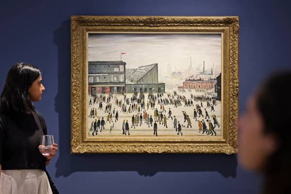 A visitor walks past "Going to the Match" by English artist LS Lowry from 1928, on display at a Christie's exhibition in Dubai on September 15, 2022