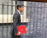 Rishi Sunak leaves Downing Street in 2020 with a burgundy coloured ring binder.
