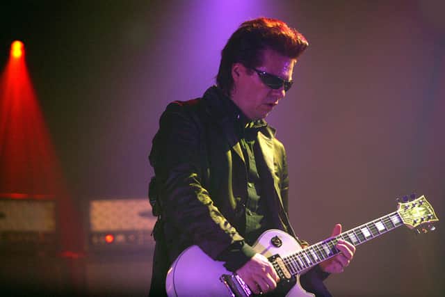 Andy Taylor of Duran Duran performs on stage during the first London date of their UK tour at Wembley Arena on April 13, 2004.