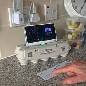 Pensioner Diane Skidmore examines her smart meter in London. 