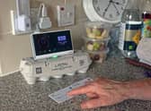 Pensioner Diane Skidmore examines her smart meter in London. 