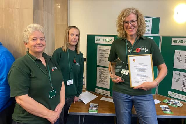 Lindsey Stockton (far right, holding framed document) with food bank colleagues