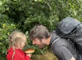 Jim Parums and his daugher foraging a mushroom - the family save £100 a week by foraging for all their meals. 