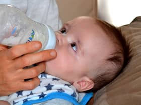 A baby drinks formula from a bottle. Pic: Pixabay.