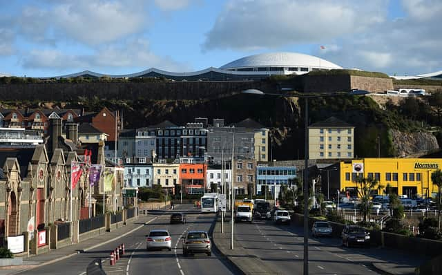 Cars travel by the seafront in St Helier, on the British island of Jersey