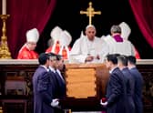 Pope Francis attends the funeral mass for Pope Emeritus Benedict XVI as pallbearers carry the coffin at the end of the funeral mass at St. Peter's square