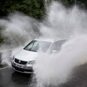 A car drives through floodwater (Photo by Matthew Horwood/Getty Images)