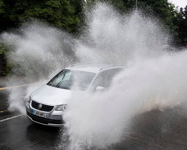 A car drives through floodwater (Photo by Matthew Horwood/Getty Images)