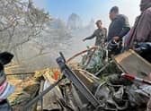 Rescuers gather at the site of a plane crash in Pokhara after an airplane crashed with 72 people on board in Nepal