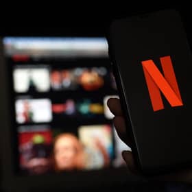 In this photo illustration a computer and a mobile phone screens display the Netflix logo on March 31, 2020 in Arlington, Virginia. (Photo by Olivier DOULIERY / AFP) (Photo by OLIVIER DOULIERY/AFP via Getty Images)
