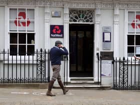 Customers use a NatWest bank on the High Street in Winchester, south west England on March 31, 2021. (Photo by ADRIAN DENNIS / AFP) (Photo by ADRIAN DENNIS/AFP via Getty Images)