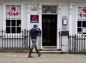 Customers use a NatWest bank on the High Street in Winchester, south west England on March 31, 2021. (Photo by ADRIAN DENNIS / AFP) (Photo by ADRIAN DENNIS/AFP via Getty Images)