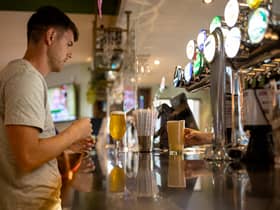 A customer buys a drink at a Wetherspoons pub in Clapham, London.