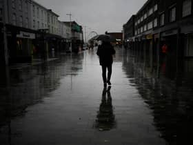 Dismal weather heralds the arrival of the UK Chancellor’s Autumn Statement as people shop in the centre of Bolton.