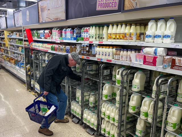 A customer shops for milk inside a Sainsbury's supermarket in east London on February 20, 2023.