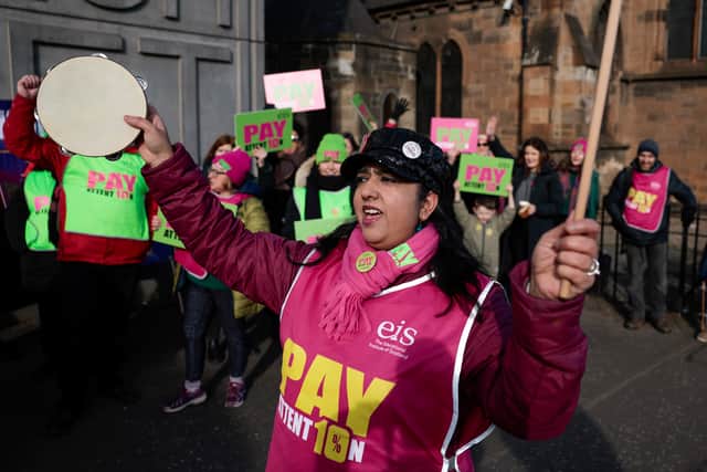 Striking teachers and supporters hold a rally on Pollokshaws Road