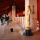 A bucket collects water leaking from the ceiling as rain from a winter storm falls on the not so red carpet arrivals area, ahead of the 95th Academy Awards, in Hollywood, California, on March 10, 2023.