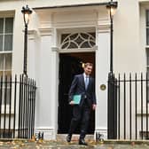 Britain's Chancellor of the Exchequer Jeremy Hunt walks out of Number 11 Downing Street 