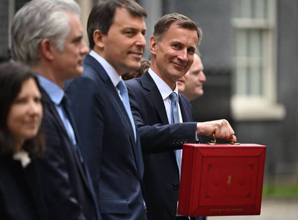 Britain’s Chancellor of the Exchequer Jeremy Hunt poses with the red Budget Box as he leaves 11 Downing Street in central London on March 15, 2023, to present the government’s annual budget to Parliament. (Photo by JUSTIN TALLIS / AFP) (Photo by JUSTIN TALLIS/AFP via Getty Images)