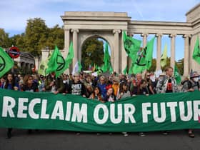 Protesters march into central London at a demonstration by the climate change protest group Extinction Rebellion, on October 16, 2022. Credit: Isabel Infantes/AFP.