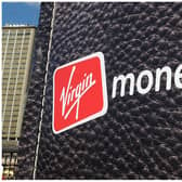 British entrepreneur Richard Branson walks out of a giant wallet as he launches Virgin Money's new credit cards in Sydney Harbour on July 27, 2010. The financial services arm of Branson's Virgin Group now offers Australians low interest rate credit cards, savings accounts, superannuation and car insurance. AFP PHOTO / Torsten BLACKWOOD (Photo by TORSTEN BLACKWOOD / AFP) (Photo by TORSTEN BLACKWOOD/AFP via Getty Images)
