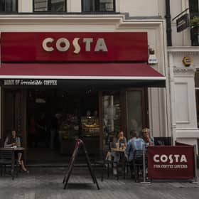 LONDON, ENGLAND - AUGUST 31: Customers sit outside a Costa Coffee store on August 31, 2018 in London, England. Coca-Cola Co. is to buy the U.K. chain Costa Coffee for £3.9 billion GBP, ($5.1 billion USD). (Photo by Dan Kitwood/Getty Images)