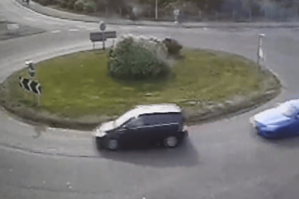 The moment a driver put their Need for Speed to the test as they drift around a busy roundabout.