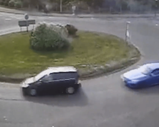 The moment a driver put their Need for Speed to the test as they drift around a busy roundabout.