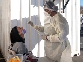 A woman receives a nasal swab, from a health worker wearing personal protective equipment (PPE), to be tested for COVID-19 at the Fourways Life Hospital in Johannesburg (Getty Images)