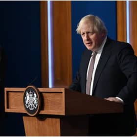 LONDON, ENGLAND - NOVEMBER 15: Prime Minister Boris Johnson standing next to British Chief Medical Officer for England Chris Whitty as he addresses the media regarding the United Kingdom's Covid-19 infection rate and vaccination campaign at Downing Street Briefing Room on November 15, 2021 in London, England. The prime minister and his advisers encouraged Britons to receive their Covid-19 vaccine booster when eligible. (Photo by Leon Neal - WPA Pool/Getty Images)