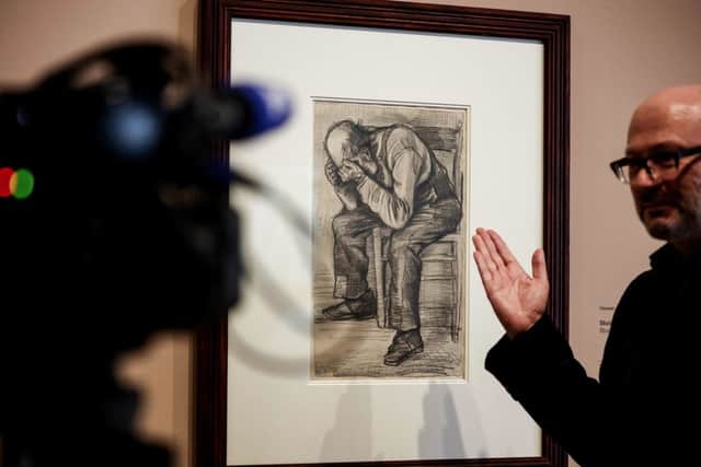 A man gives explanations in front of a newly discovered work by Vincent van Gogh "Study for "Worn out" from 1882 (photo: Kenzo Tribouillard/AFP via Getty Images)