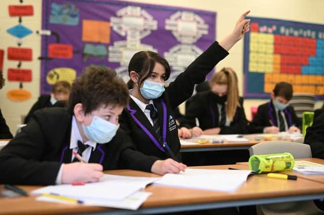 Schools have been advised to hold lessons outside. (Photo by OLI SCARFF/AFP via Getty Images)
