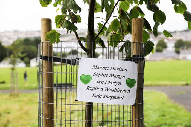 People pay their respects to the five shooting victims at North Down Crescent Park on August 15 in Plymouth (William Dax/Getty)