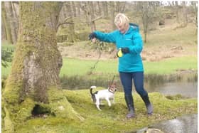Murdered PCSO Julia James walking her Jack Russell Toby and wearing a light blue waterproof coat, blue jeans and dark coloured Wellington style brown boots - the same clothes she had on when last seen before her murder (Kent Police)