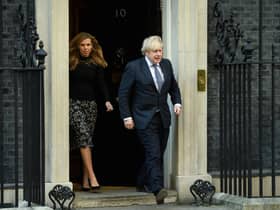 Prime Minister Boris Johnson and his partner Carrie Symonds stand outside the door of number 10 Downing Street (Photo by Leon Neal/Getty Images)